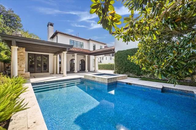 a view of house with swimming pool outdoor seating