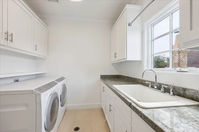 a view of a kitchen with sink washer and dryer