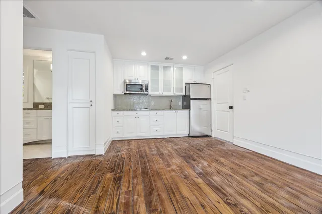 a view of a kitchen with wooden floor and a sink