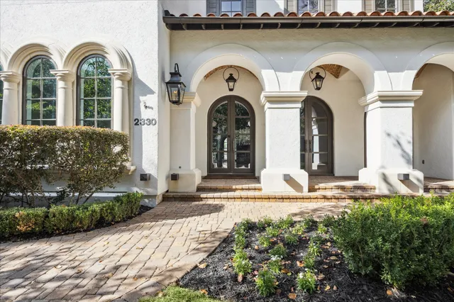 a front view of a house with lots of yellow lighting