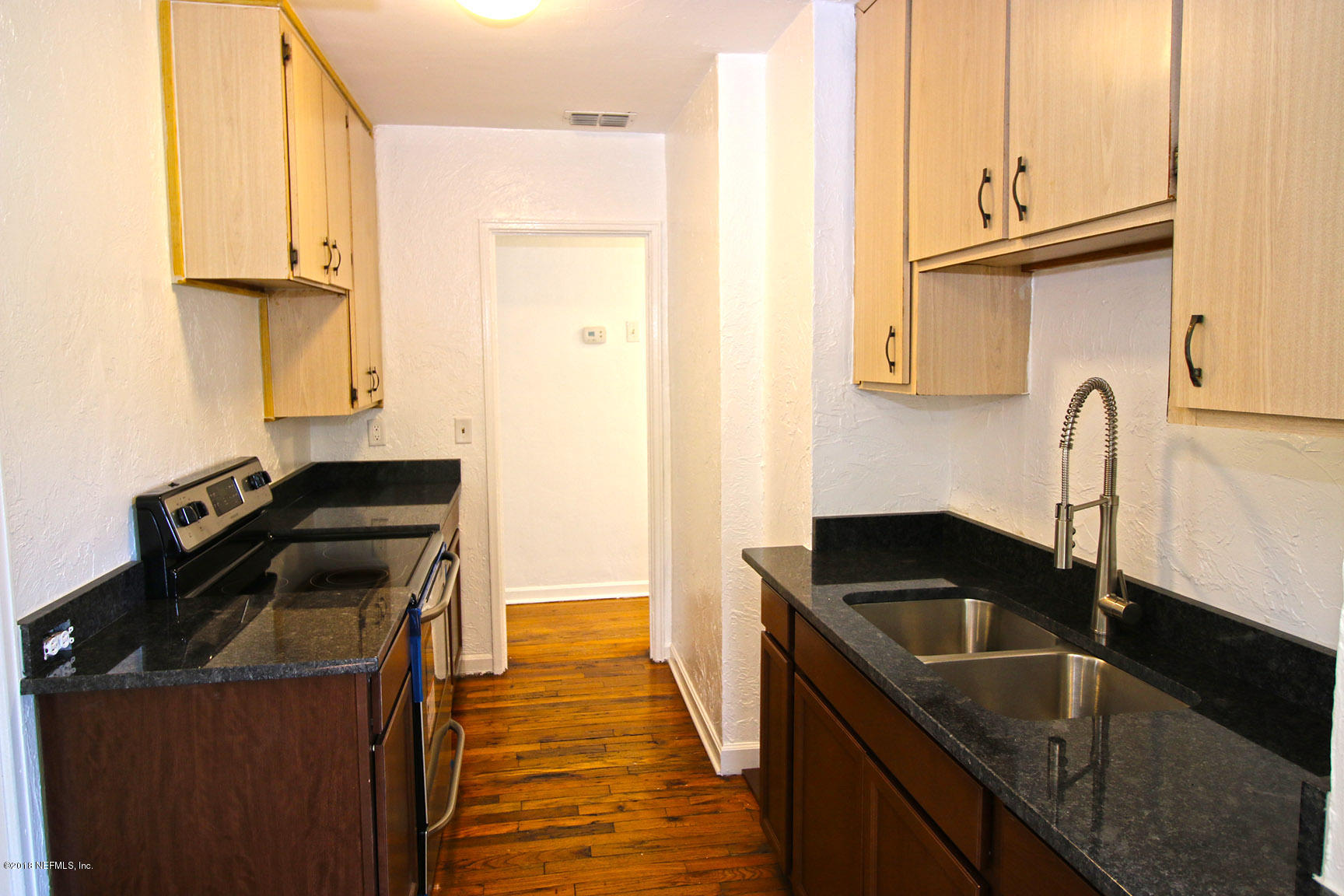 4934 Dundee Road Jacksonville, FL 32210 - Photo 7 of 15 a kitchen that has a sink and a stove