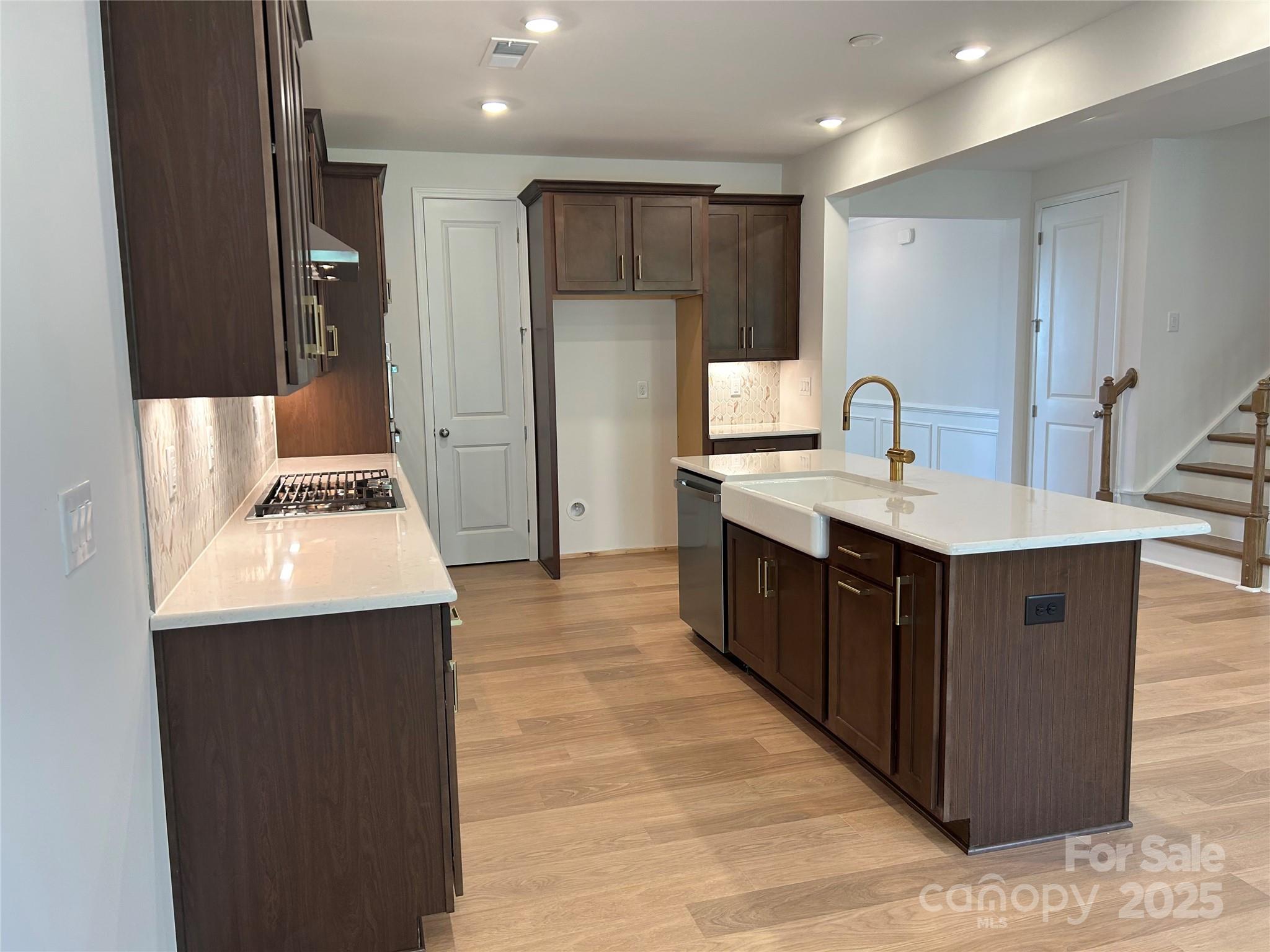 1431 Hubert Graham Way Tega Cay, SC 29708 - Photo 6 of 24 a kitchen with a sink and a refrigerator