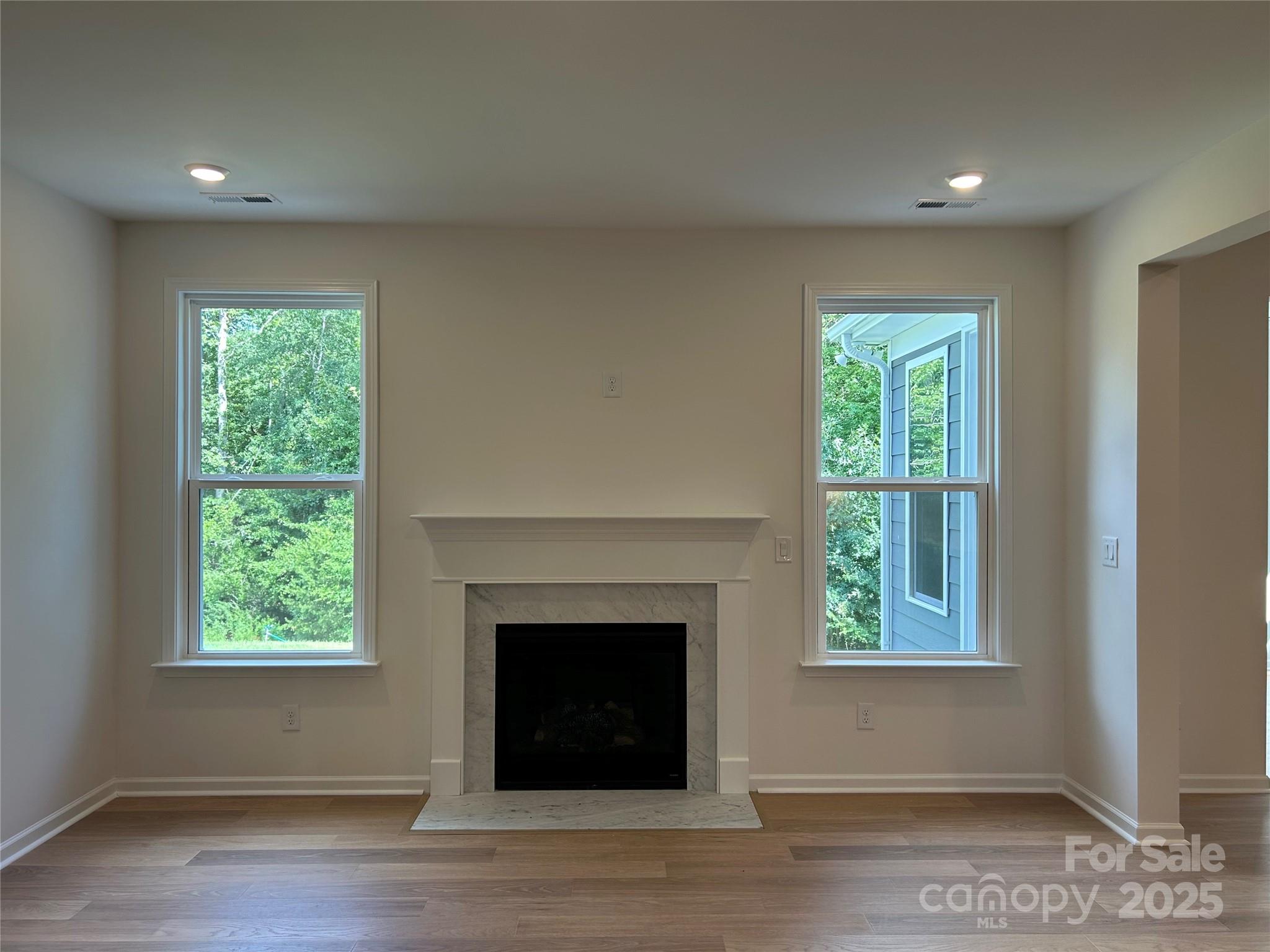 1431 Hubert Graham Way Tega Cay, SC 29708 - Photo 7 of 24 a living room with a fireplace and a window
