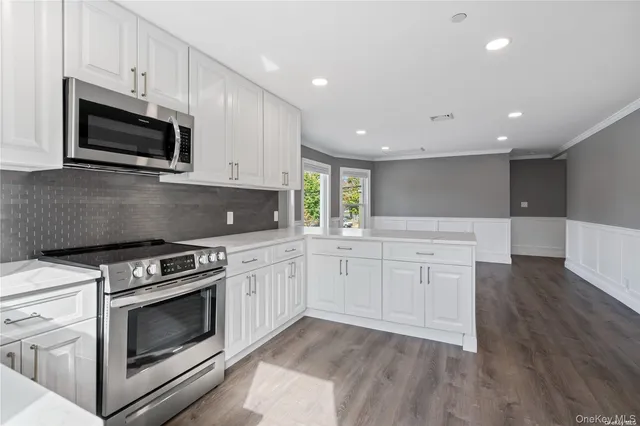 a kitchen with appliances a sink and cabinets
