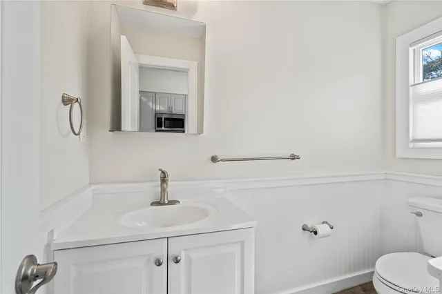 a bathroom with a sink toilet and mirror
