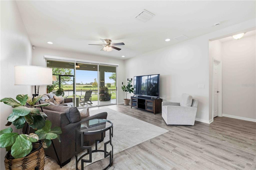 10920 79th Street East Parrish, FL 34219 - Photo 16 of 73 a living room with furniture a large window and a flat screen tv
