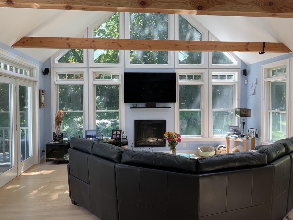 270 Hay Road Eastham, MA 02642 - Photo 1 of 42 a living room with fireplace furniture large window and garden