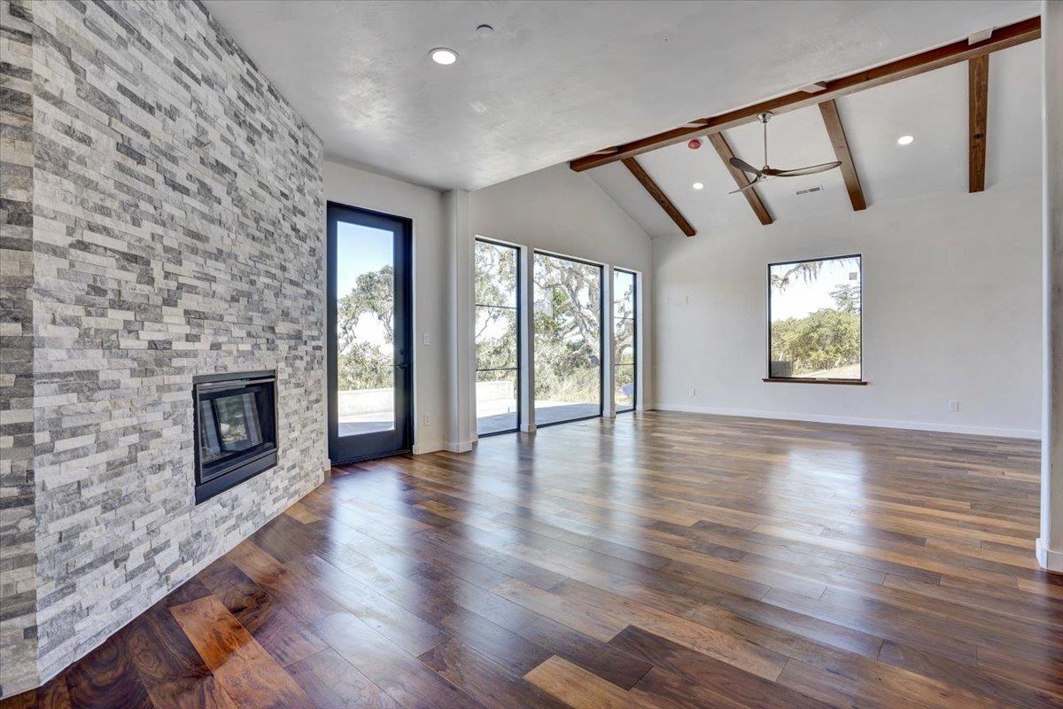 8360 Monterra Views Monterey, CA 93940 - Photo 28 of 82 an empty room with wooden floor fireplace and windows