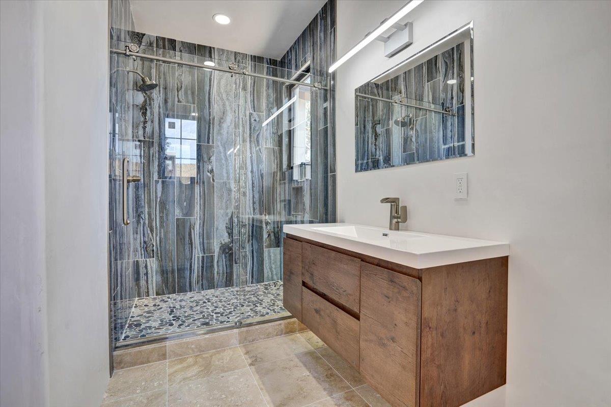 8360 Monterra Views Monterey, CA 93940 - Photo 30 of 82 a bathroom with a sink a mirror and a shower