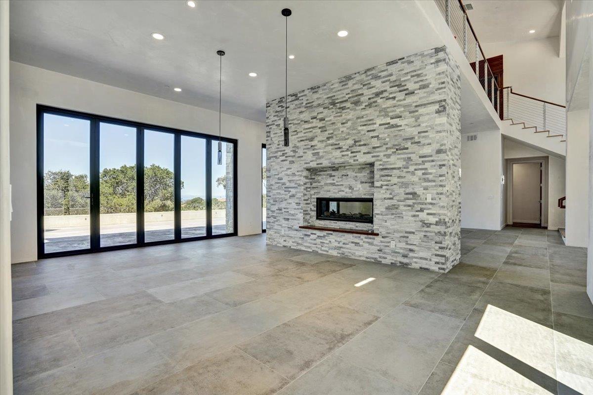 8360 Monterra Views Monterey, CA 93940 - Photo 33 of 82 a view of an empty room with a fireplace and a floor to ceiling window