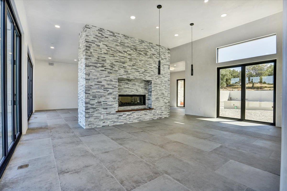 8360 Monterra Views Monterey, CA 93940 - Photo 35 of 82 a view of an empty room with a fireplace and a chandelier