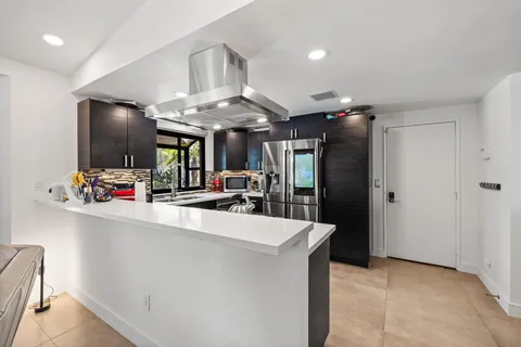 a view of living room with furniture and kitchen view
