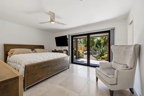 a bedroom with a bed couch and window