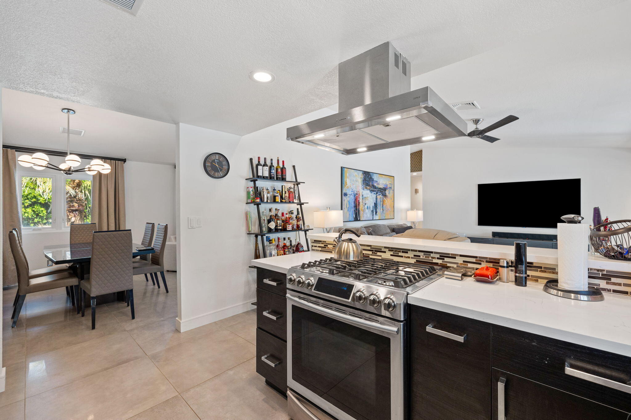 2777 East San Juan Road Palm Springs, CA 92262 - Photo 14 of 31 a kitchen with a stove a sink and a dining table with white walls