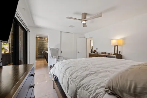 a spacious bedroom with a bed and a chandelier