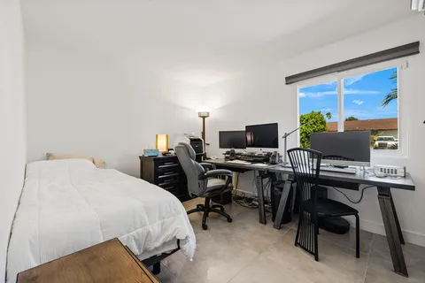 a bedroom with a workspace