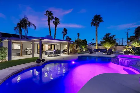 a view of swimming pool with outdoor seating