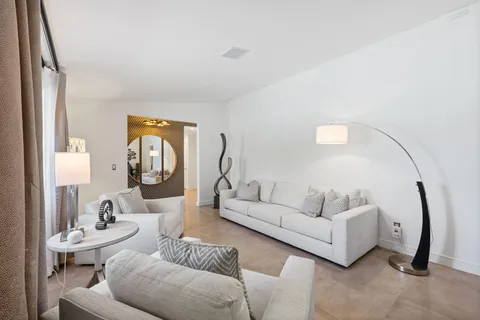 a living room with furniture and a mirror