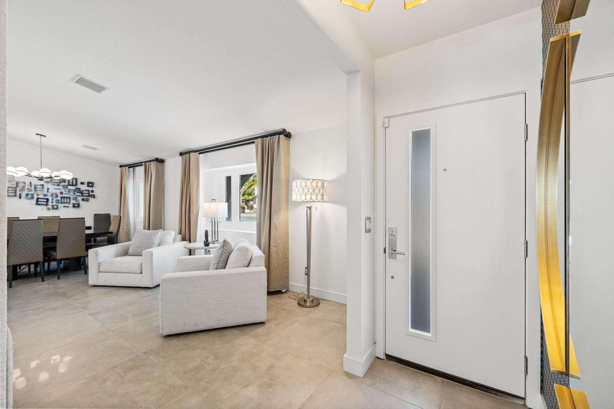 2777 East San Juan Road Palm Springs, CA 92262 - Photo 6 of 31 a living room with furniture and a chandelier