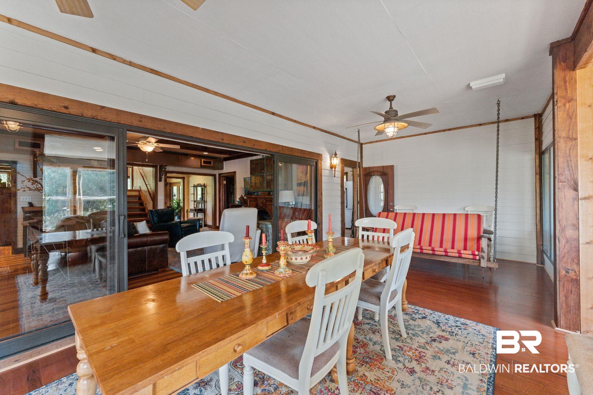 16451 Honey Road Summerdale, AL 36580 - Photo 17 of 55 Dining area featuring wood finished floors, ceiling fan, ornamental molding, wood walls, and a sunroom