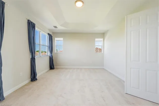 an empty room with windows and closet