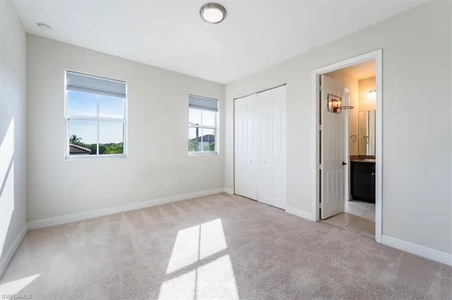 an empty room with windows and closet