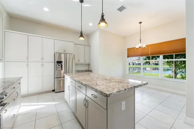 a kitchen with a stove a refrigerator and a wooden floor