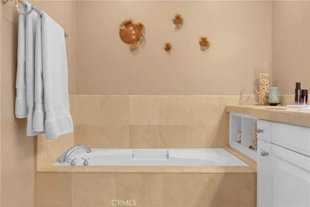 a bathroom with a bathtub sink and vanity