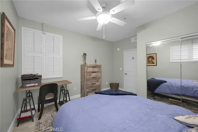 a bedroom with a bed a desk and chair