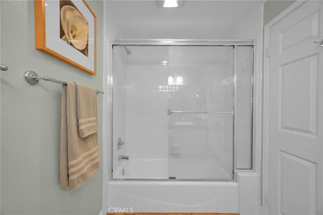 a bathroom with a glass shower door