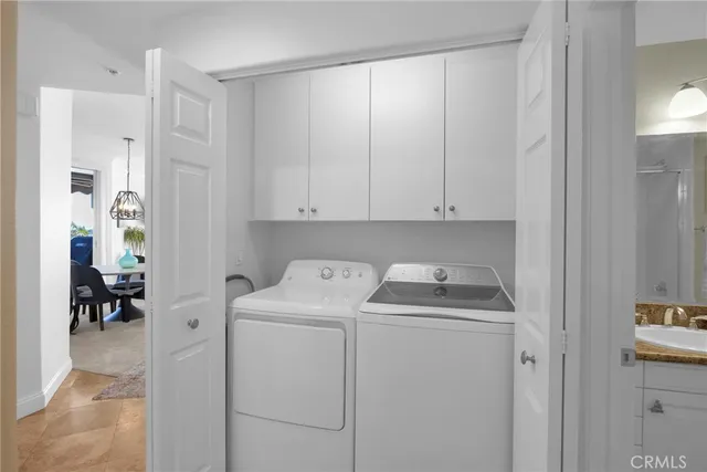 a view of storage and utility room with closet dryer