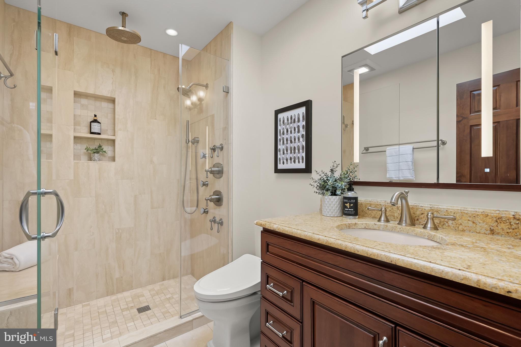 1745 S Street Northwest Washington, DC 20009 - Photo 14 of 19 a bathroom with a granite countertop sink a toilet and shower