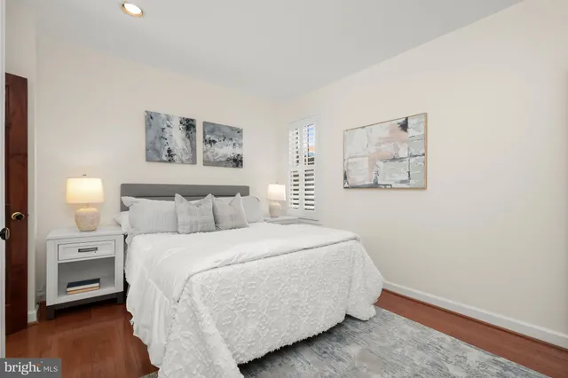 a bedroom with a bed and a night stand