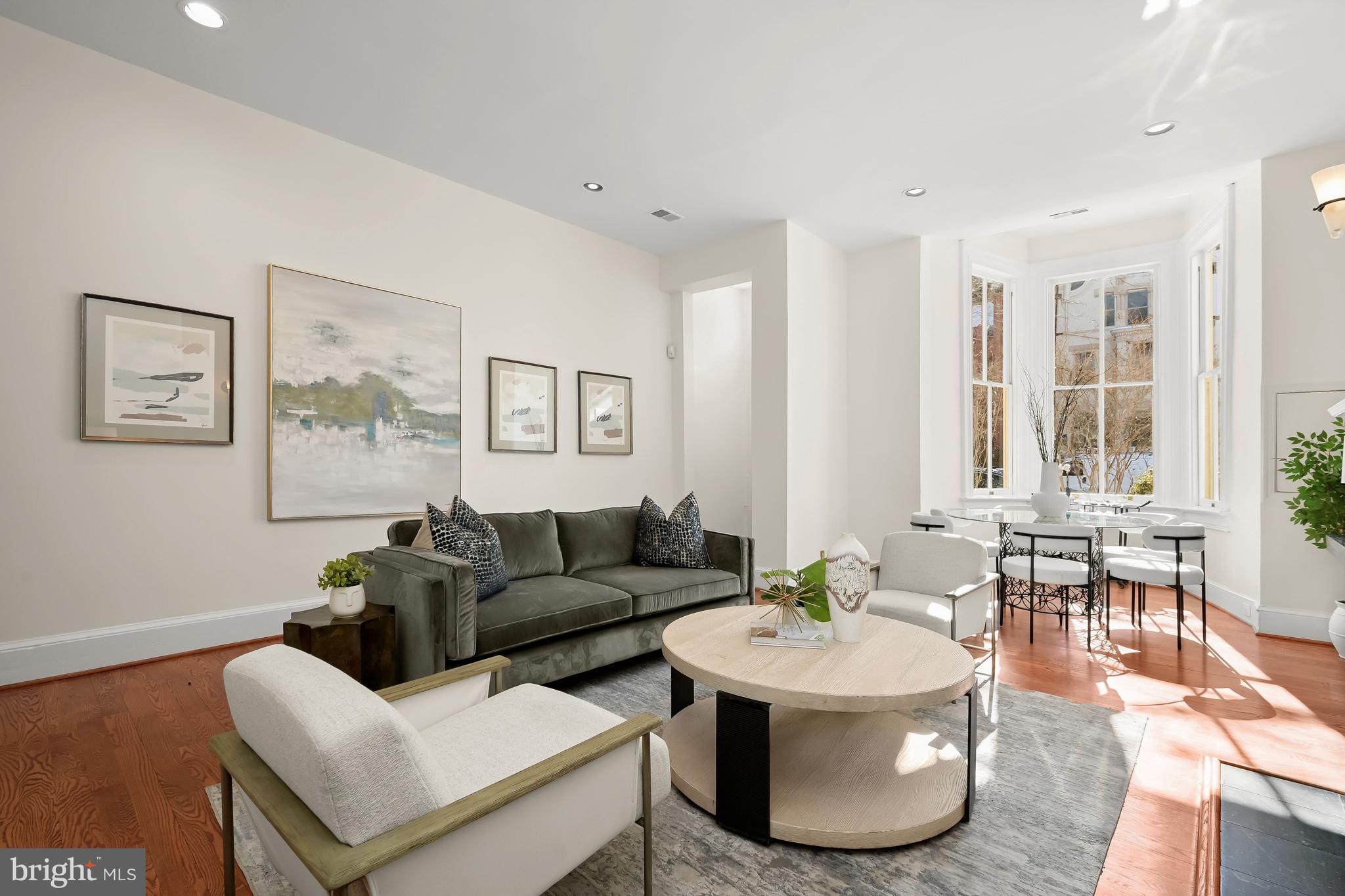 1745 S Street Northwest Washington, DC 20009 - Photo 3 of 19 a living room with couches and a dining table with wooden floor