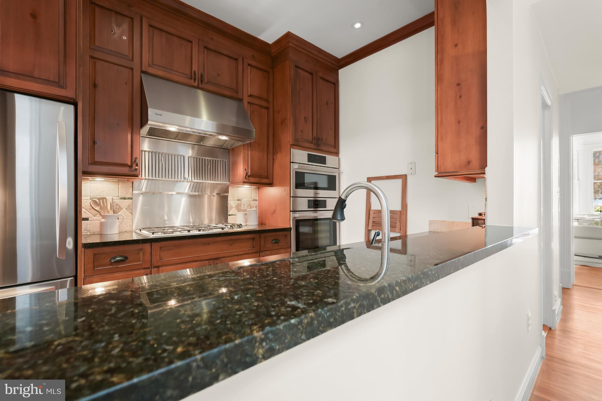 1745 S Street Northwest Washington, DC 20009 - Photo 7 of 19 a kitchen with granite countertop a sink and a refrigerator