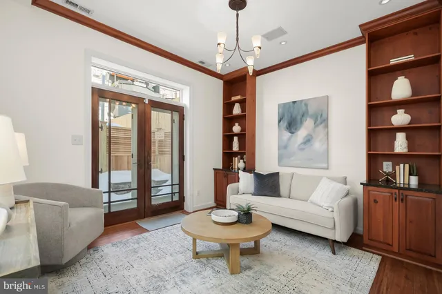 a living room with furniture and a painting