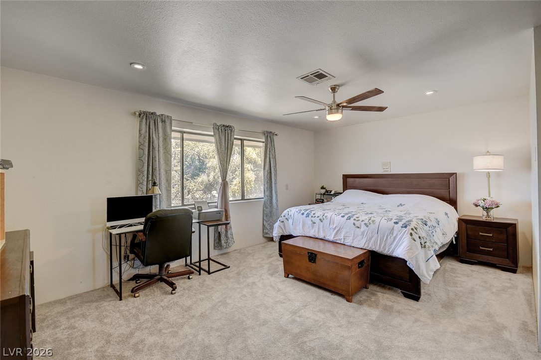 1920 Bowman Road Logandale, NV 89021 - Photo 35 of 68 Plush carpeting and recessed lighting create a comfortable atmosphere in this spacious bedroom.