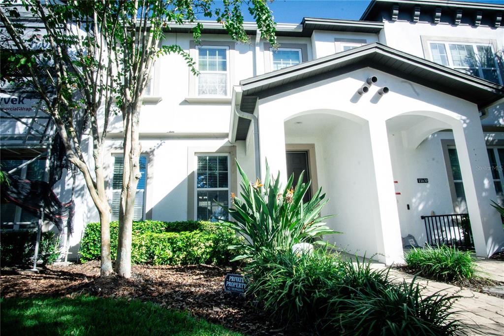 11636 Water Run Alley Windermere, FL 34786 - Photo 2 of 18 a front view of a house with lake view