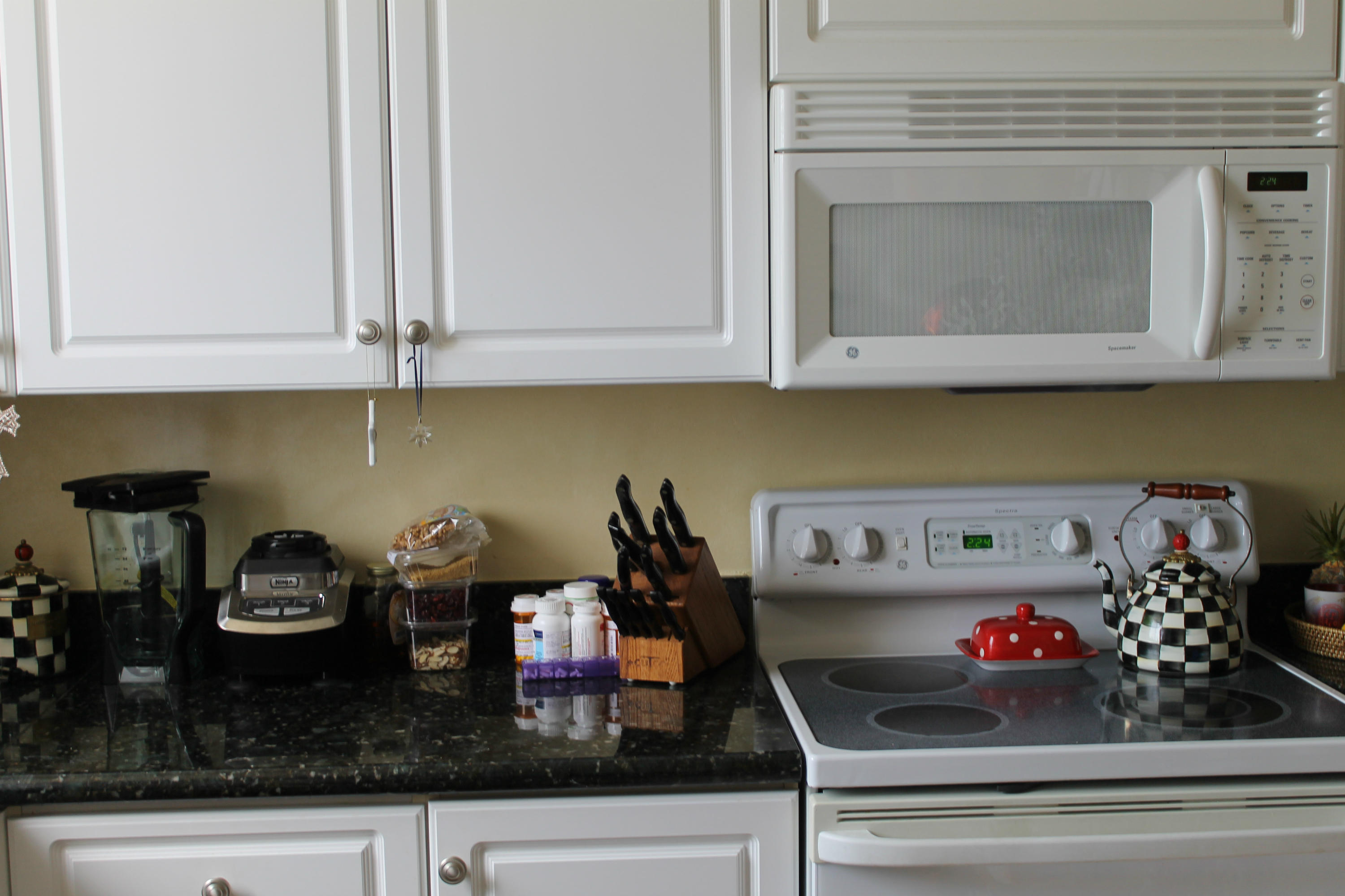 300 Ocean Trail Way, Unit 1010 Jupiter, FL 33477 - Photo 11 of 25 a kitchen with a stove and cabinets