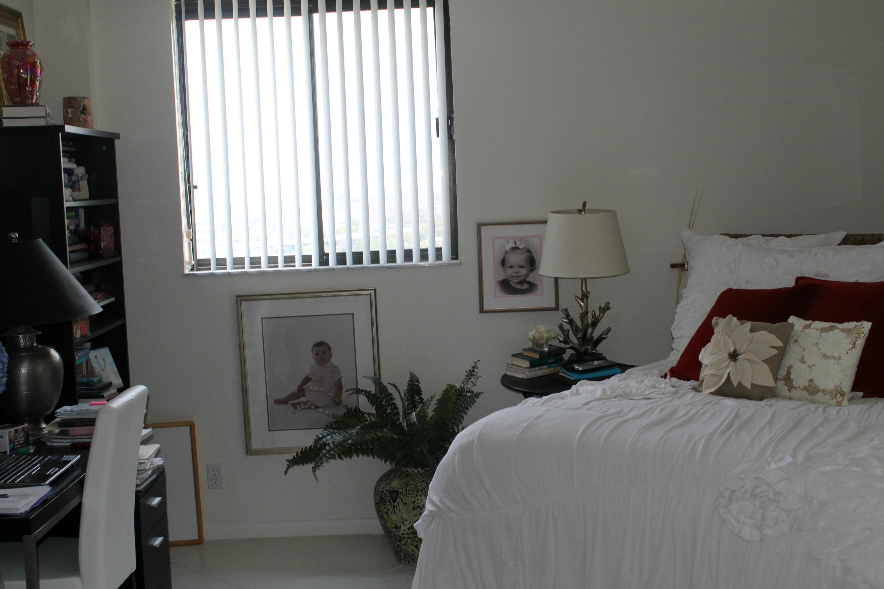 300 Ocean Trail Way, Unit 1010 Jupiter, FL 33477 - Photo 15 of 25 a bedroom with a bed a window and potted plants on the dresser