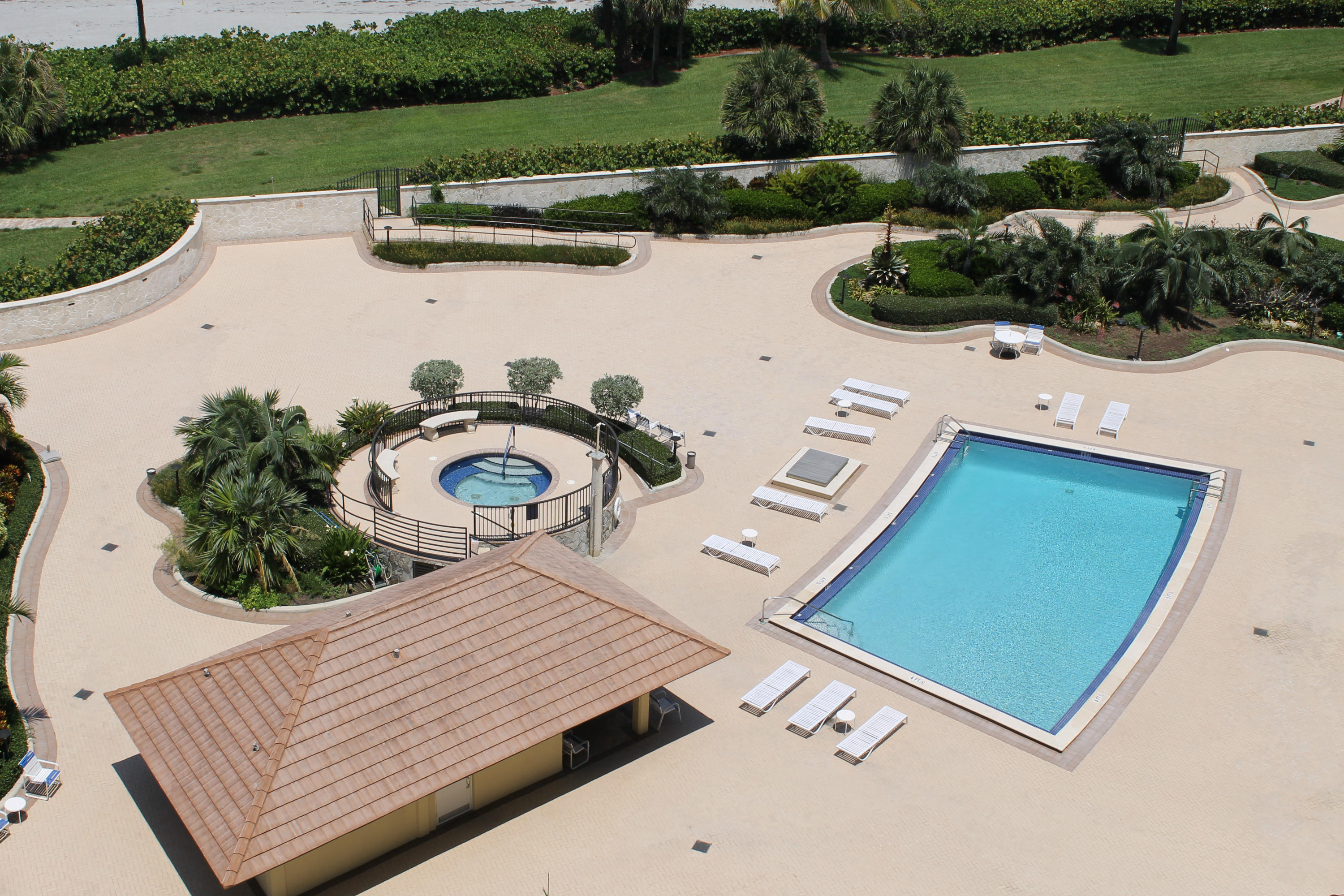 300 Ocean Trail Way, Unit 1010 Jupiter, FL 33477 - Photo 4 of 25 a view of a patio with table and chairs near a garden