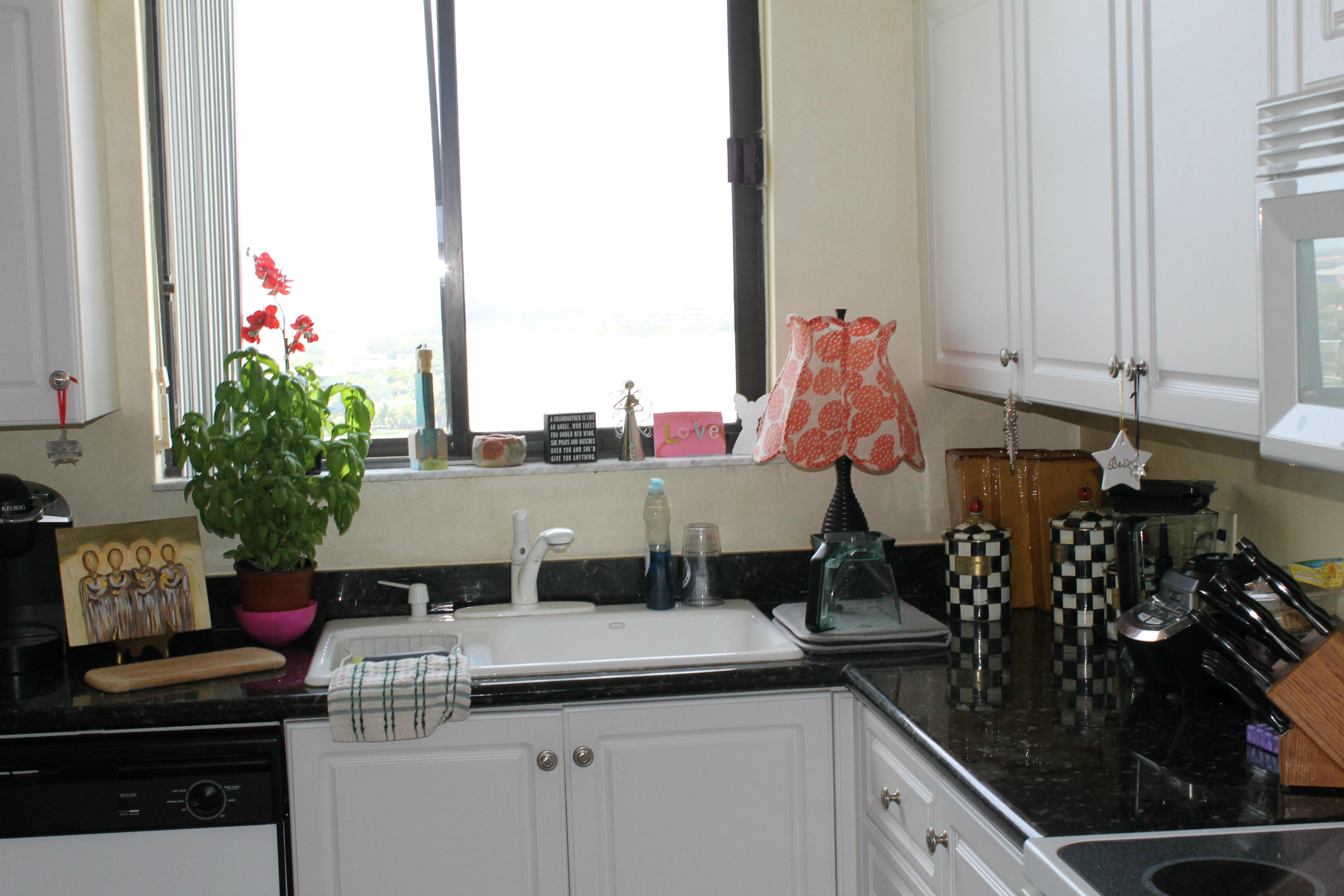 300 Ocean Trail Way, Unit 1010 Jupiter, FL 33477 - Photo 8 of 25 a kitchen with a stove and cabinets
