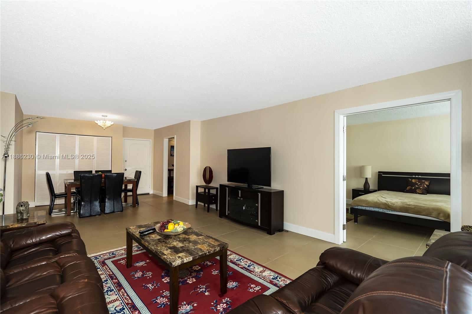 2030 South Ocean Drive, Unit 1118 Hallandale Beach, FL 33009 - Photo 13 of 58 a living room with furniture and a flat screen tv
