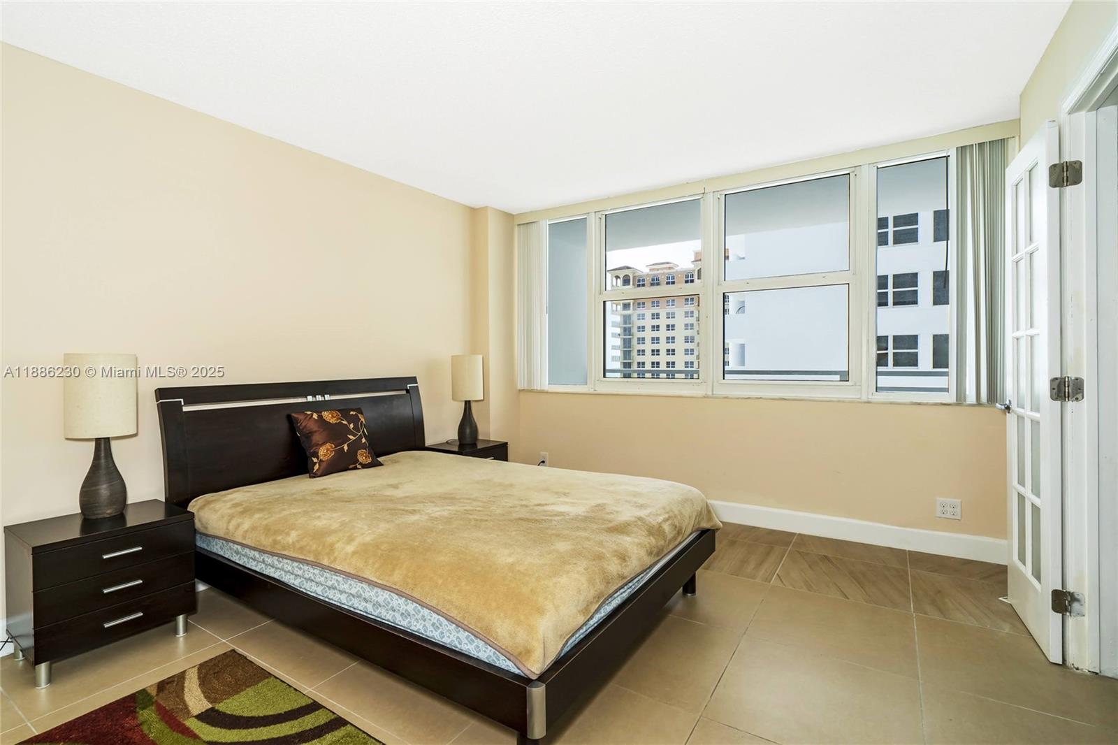 2030 South Ocean Drive, Unit 1118 Hallandale Beach, FL 33009 - Photo 31 of 58 a bedroom with a bed and wooden floor