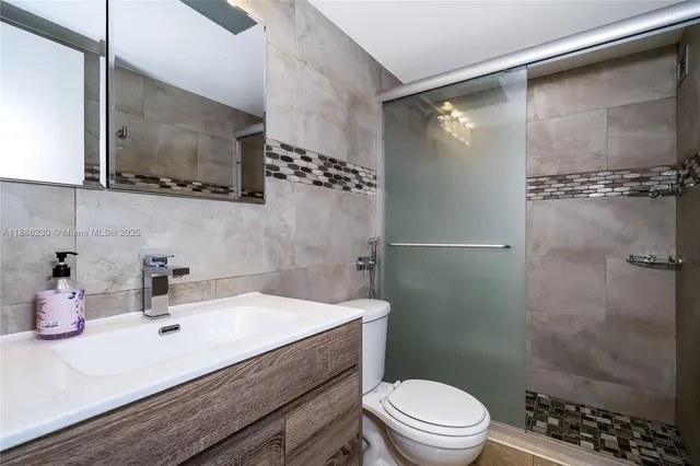 a bathroom with a sink vanity and a mirror
