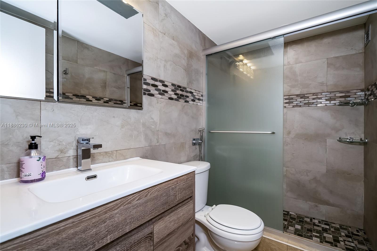 2030 South Ocean Drive, Unit 1118 Hallandale Beach, FL 33009 - Photo 32 of 58 a bathroom with a sink a toilet and shower