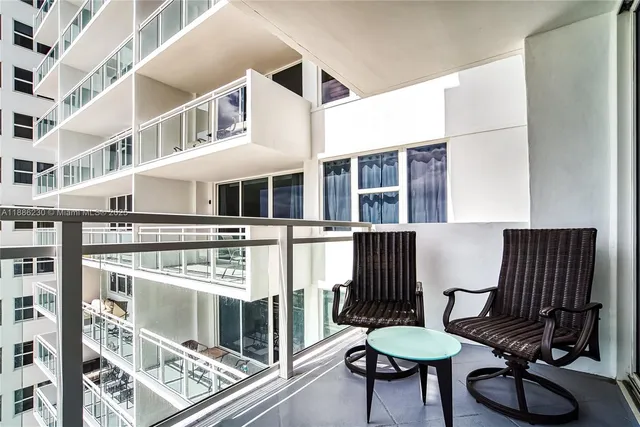 a lobby with furniture and a glass door shower