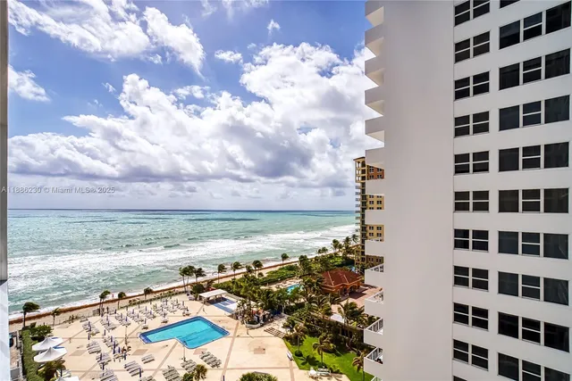 a view of a dining room with a table and chairs