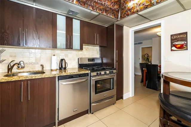 a kitchen with stainless steel appliances granite countertop a stove and a sink