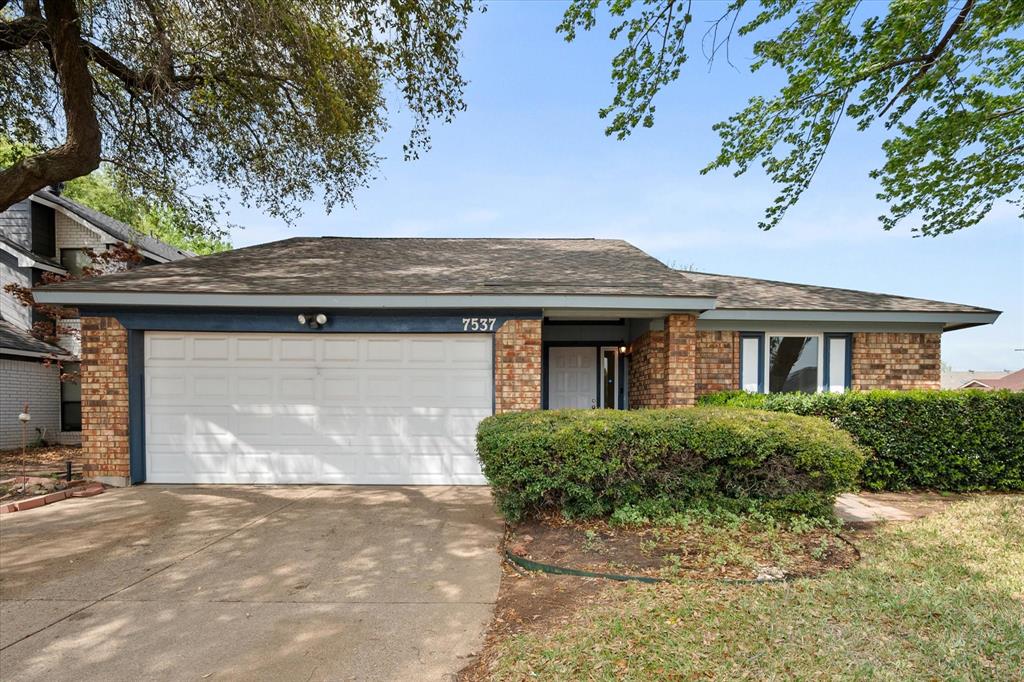 7537 Down Hill Drive Fort Worth, TX 76120 - Photo 1 of 1 a front view of a house with a yard and garage